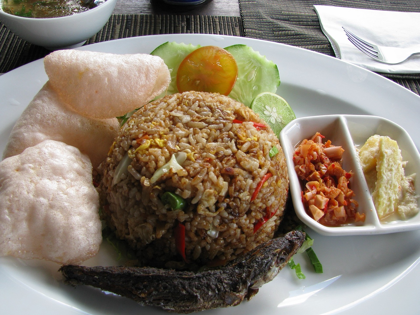 A plate of nasi goreng kampung topped with a fried egg.