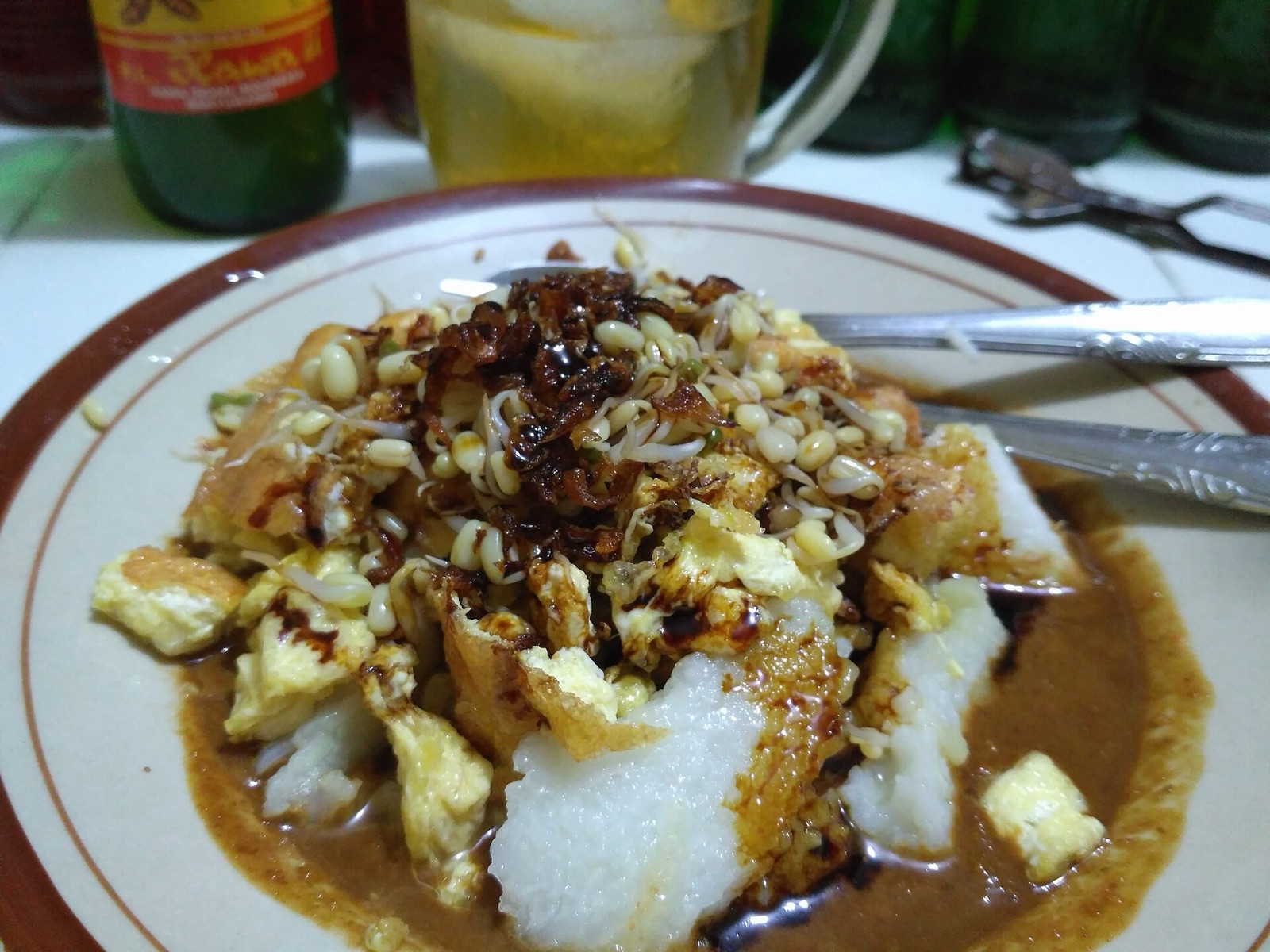 A plate of tahu telur, broken tofu omelette in peanut sauce.