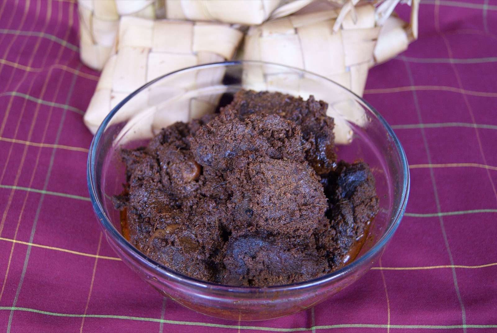 A plate of beef rendang in deep, dark sauce.